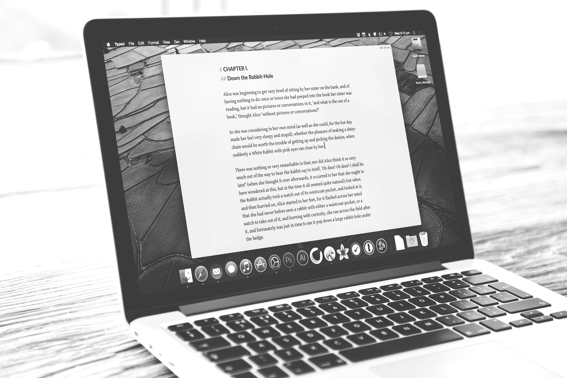 Laptop displays a document, possibly a letter.